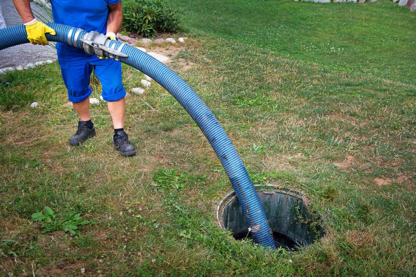 Emptying household septic tank. Cleaning sludge from septic system.